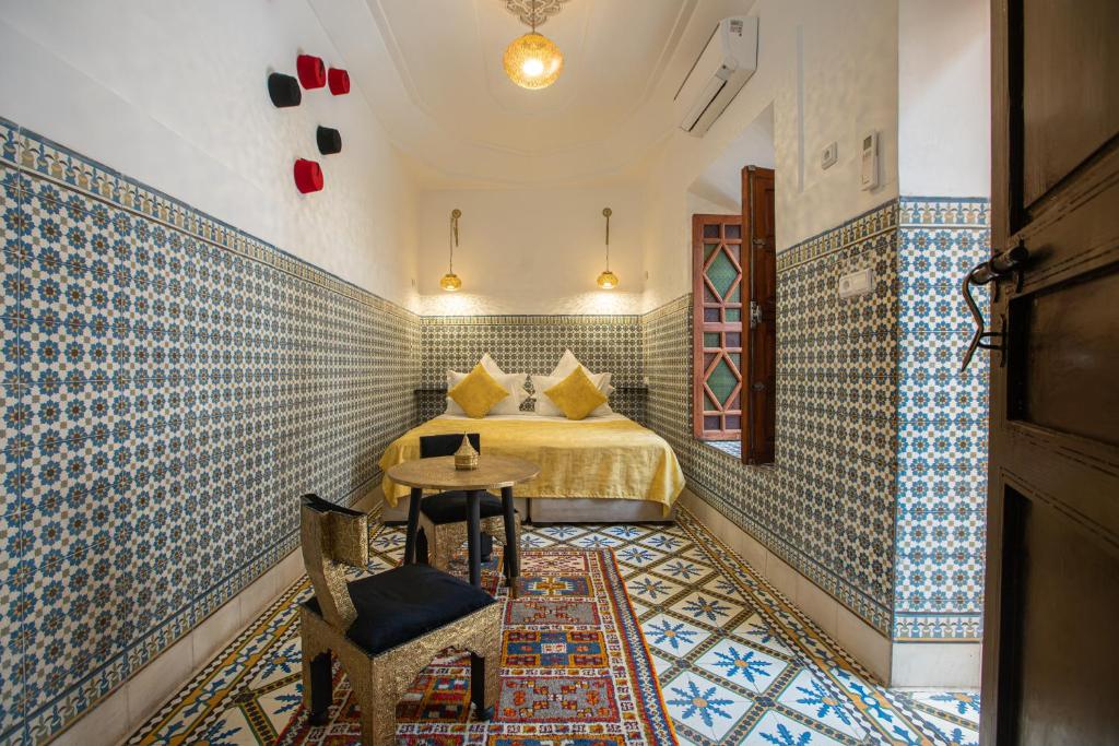 une chambre avec un lit et une table dans une pièce dans l'établissement Riad Albaraka, à Marrakech 37 autres photos