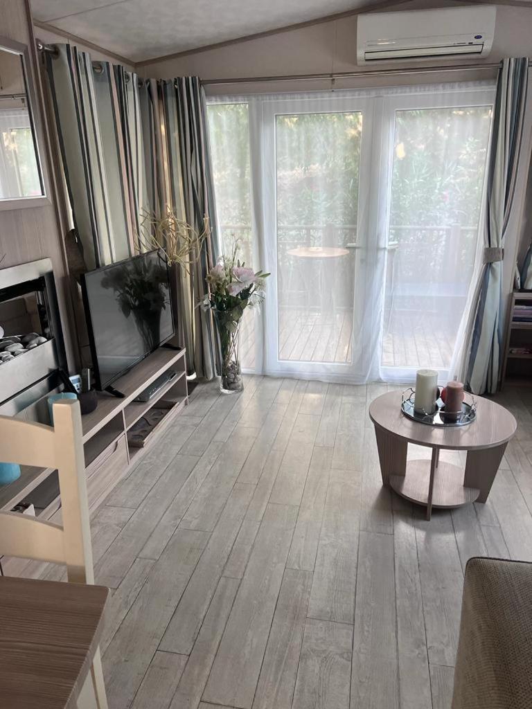 - un salon avec une grande fenêtre et une table basse dans l'établissement Mobil home le Montourey, à Fréjus