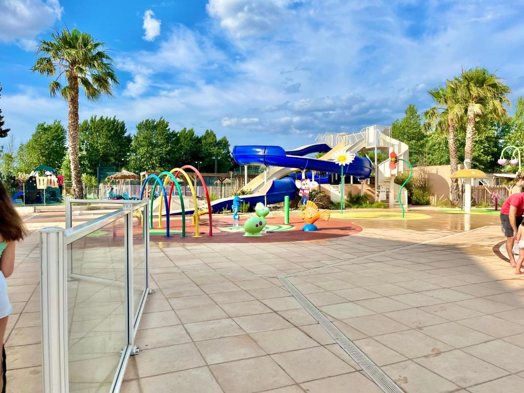un parc avec un parc aquatique et une aire de jeux dans l'établissement Mobil Home 2CH Bien Equipé Valras-Plage, à Sérignan