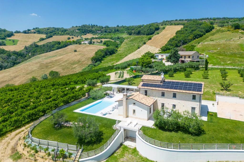 - une vue aérienne sur une maison avec une piscine sur une colline dans l'établissement Villa Amore di Ada - Modern Design Villa - AirCo, Private Pool & Near The Beach, à Monterubbiano 40 autres photos
