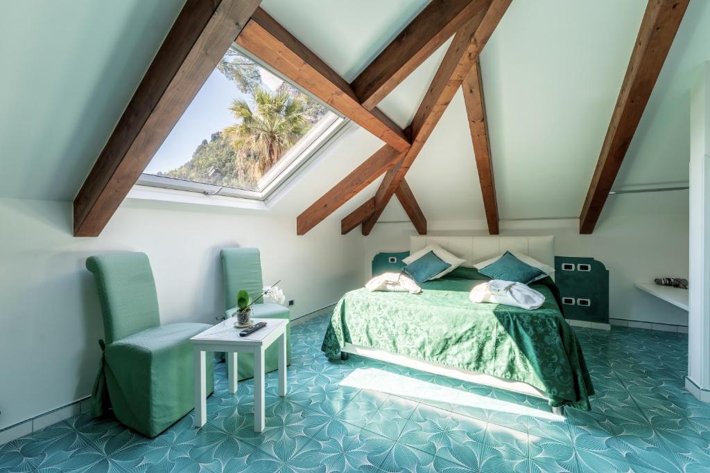 une chambre avec un lit et une lucarne dans l'établissement Hotel Relais Villa Annalara, à Amalfi