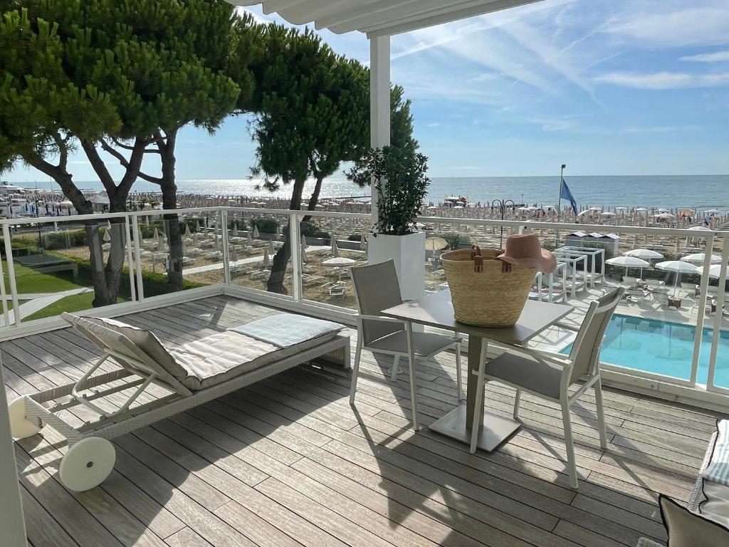 une table et des chaises sur une terrasse avec vue sur la plage dans l'établissement Hotel Ril, à Lido di Jesolo