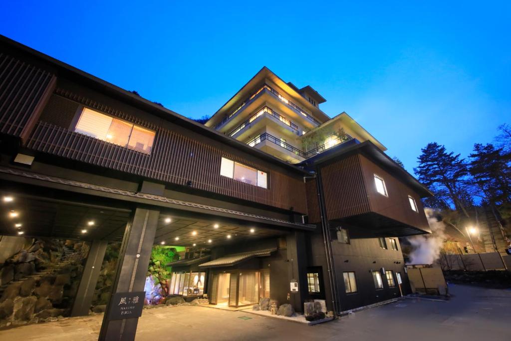 un grand bâtiment éclairé la nuit dans l'établissement Naruko Fuga, à Osaki