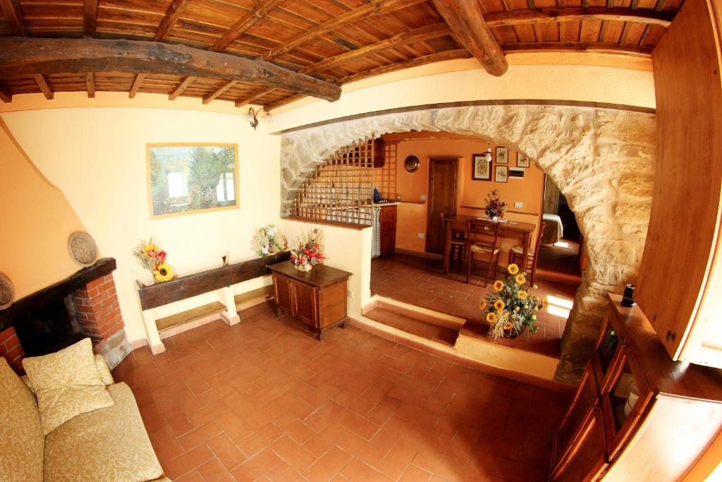 - un salon avec un mur en pierre dans l'établissement Tuscany Villa Chianti Hills - Villa Oliveta, à Loro Ciuffenna