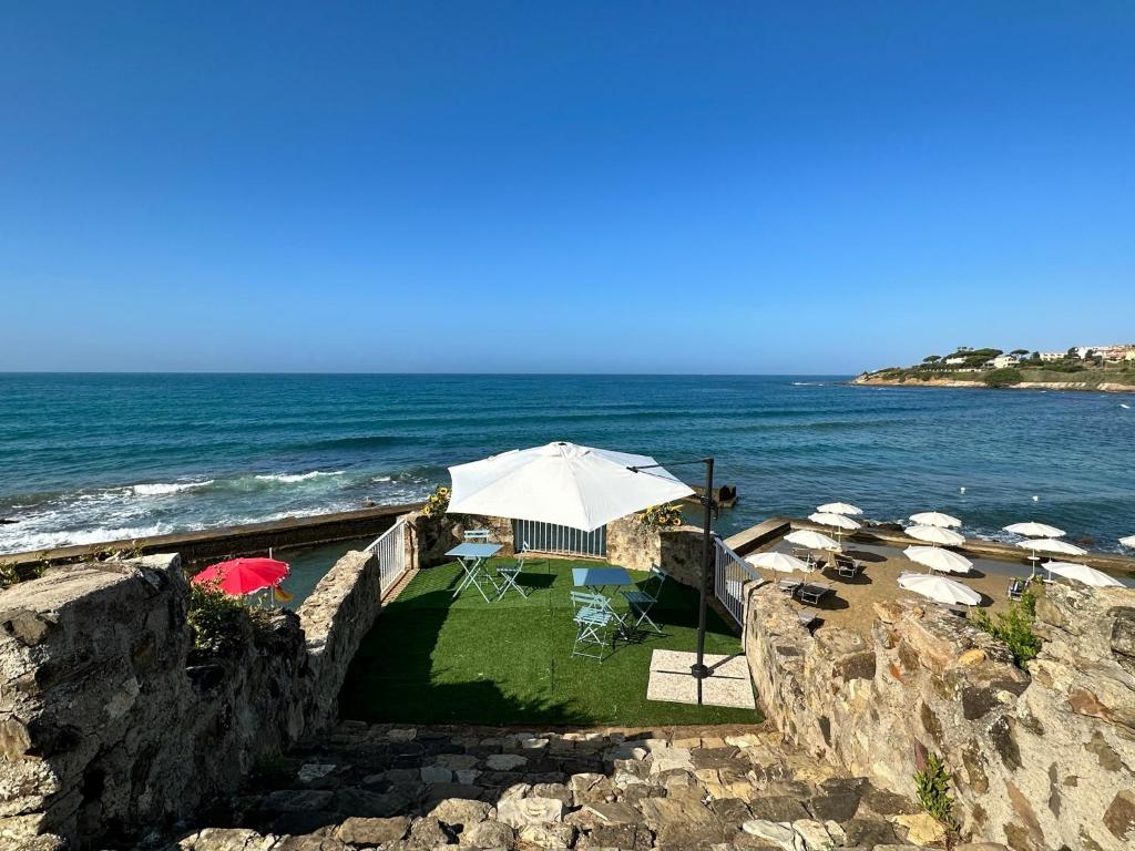 - une plage avec des parasols et des chaises et l'océan dans l'établissement Villa MG Hotel, à Santa Marinella