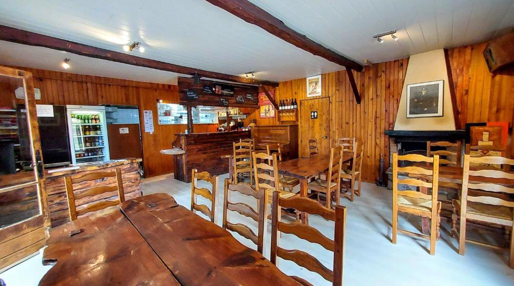 une salle à manger avec des tables et des chaises en bois dans l'établissement Camping Les Sirènes, à Castellane 18 autres photos
