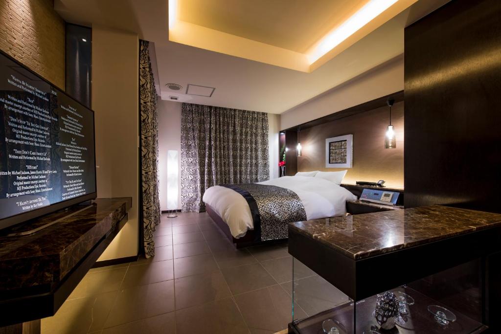 une chambre d'hôtel avec un lit et un bureau dans une chambre dans l'établissement コスタリゾート千葉北（大人専用）, à Shimo-shizu