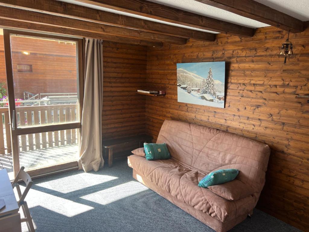 d'un salon avec un canapé et un balcon. dans l'établissement Orcières-Merlette le Panoramic, à Orcières