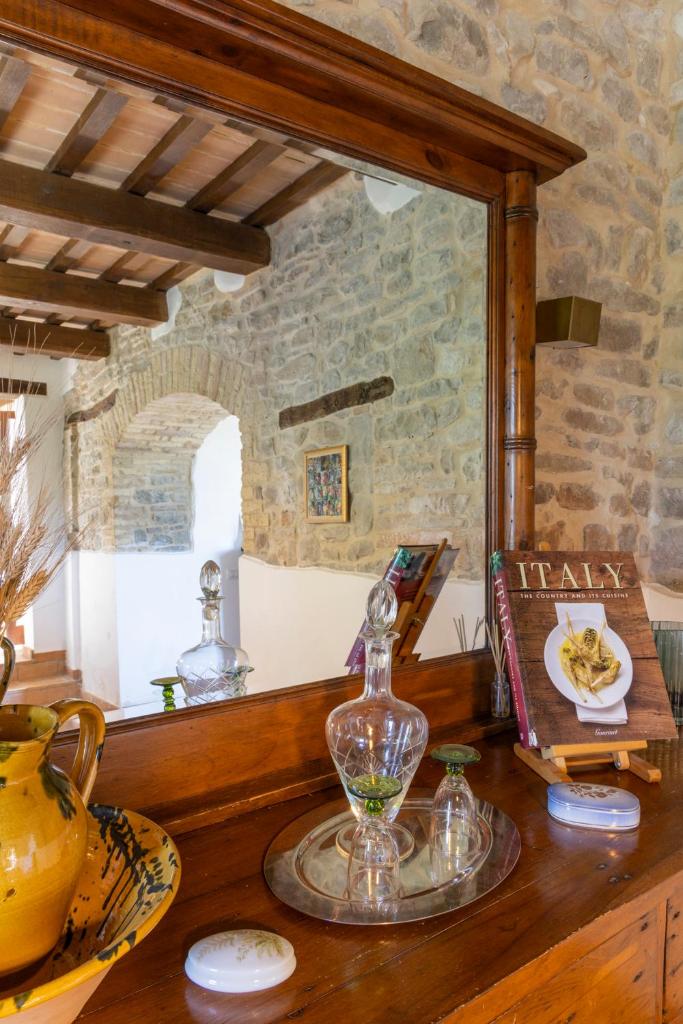 une table avec un vase en verre et un miroir dans l'établissement Grano - Casa Bella Vista, à Force