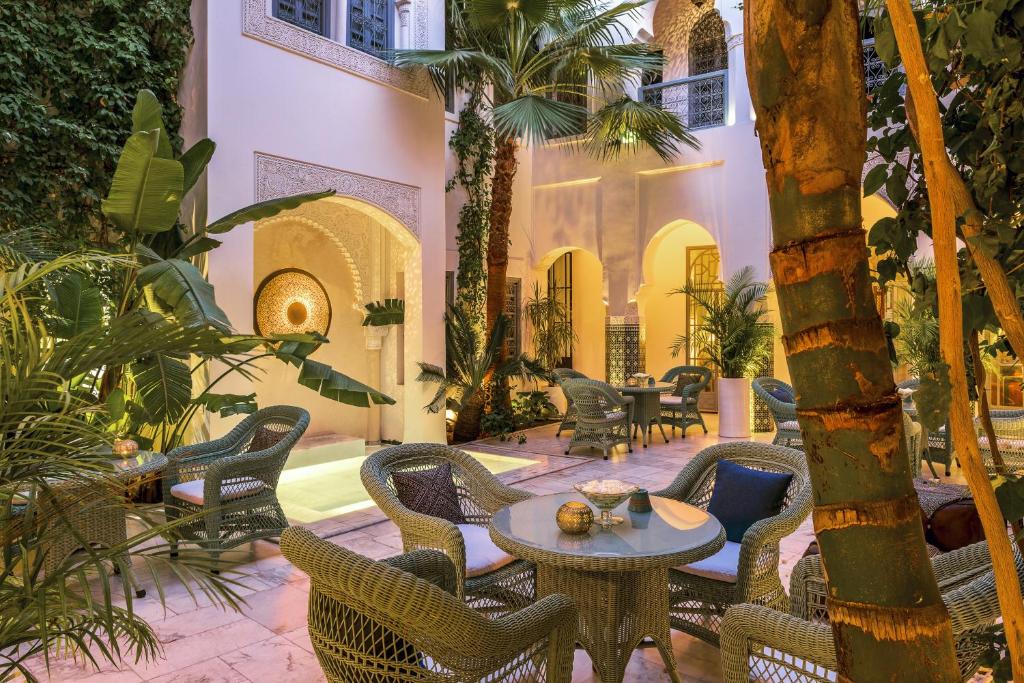une cour avec des chaises et des tables. dans l'établissement Riad Idra, à Marrakech