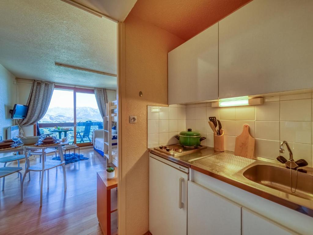 une cuisine avec un évier et un plan de travail dans l'établissement Studio Pegase Phenix-73 by Interhome, au Corbier