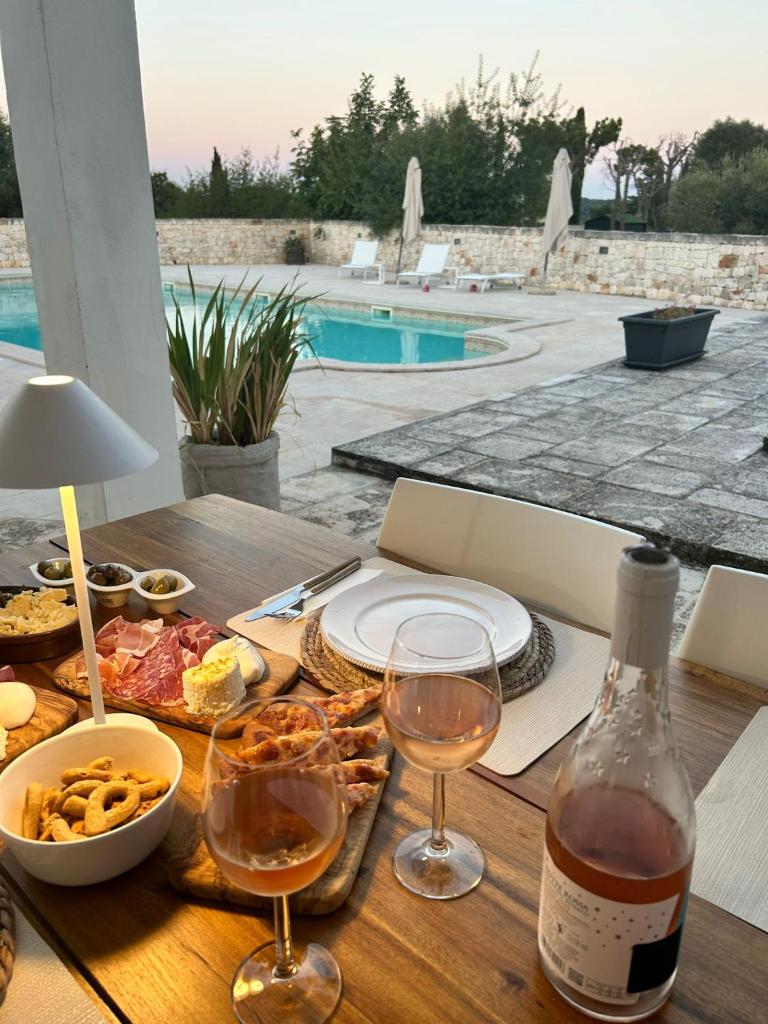 - une table avec des verres de vin et de la nourriture dans l'établissement Villa Magis, à Ostuni