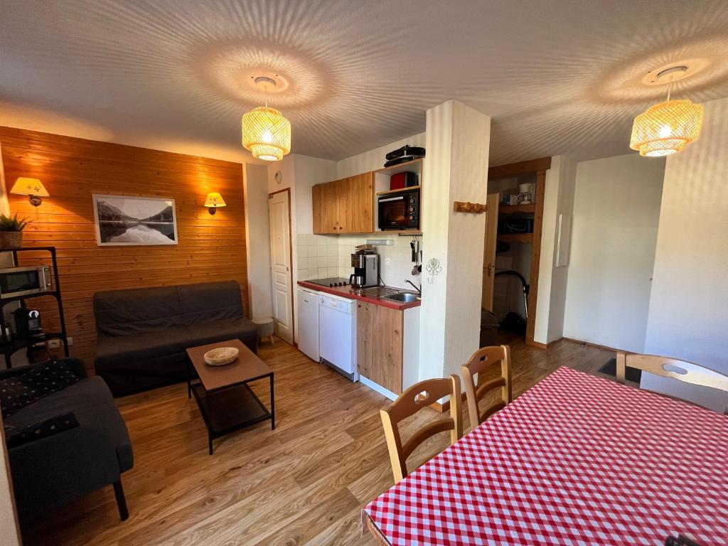un salon avec une table et une cuisine dans l'établissement Charmant appartement confortable pour 6 personnes 40m2 pied pistes, Piscine, wifi, parking, à Chamrousse 33 autres photos