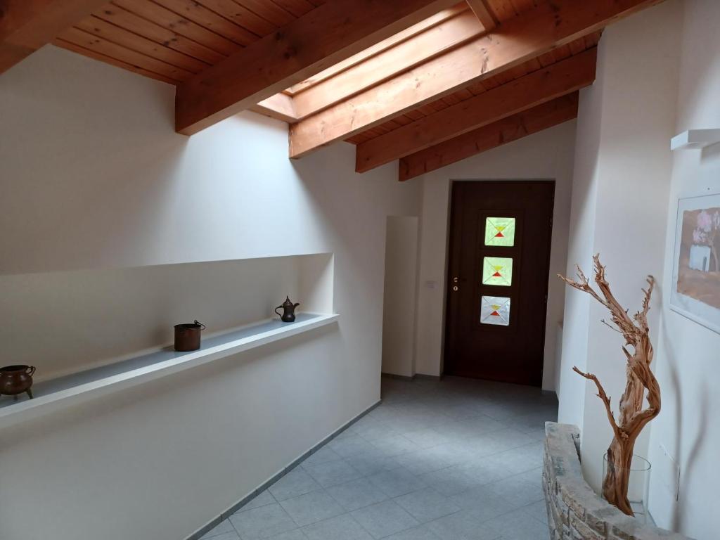 un couloir avec des murs blancs et un plafond en bois dans l'établissement Penthouse in the green with private pool and garden, à Portula