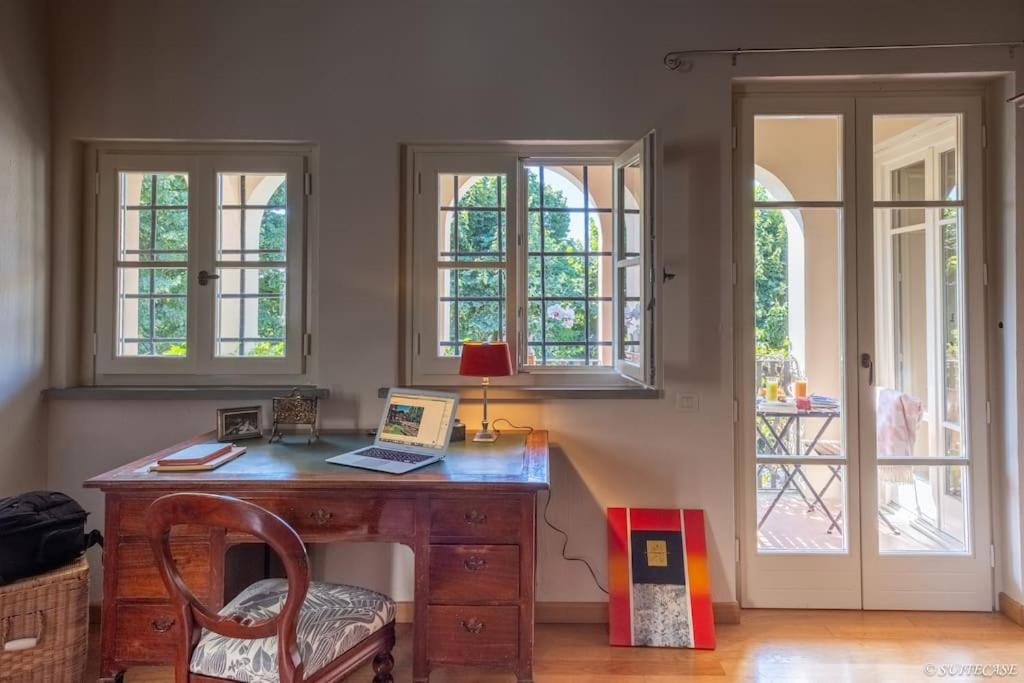 - un bureau avec un ordinateur portable dans une chambre dotée de fenêtres dans l'établissement Atmosfera Japandi e Ricordi Lontani ,Luxury & Pool!, à Lucques