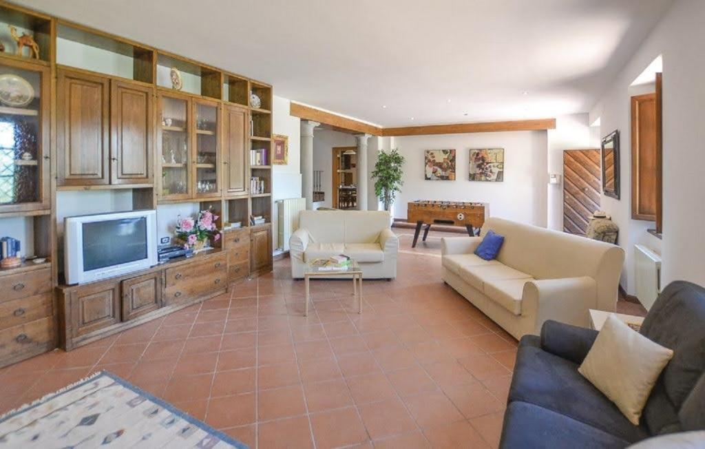 un salon avec un canapé et une télévision dans l'établissement Villa Brenda by VacaVilla, à Pratovecchio