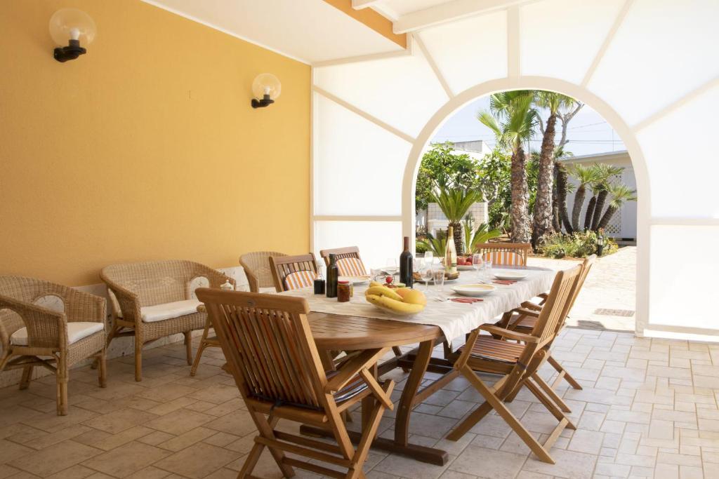 une salle à manger avec une table et des chaises en bois dans l'établissement Villa Eleonora con piscina Fronte Mare, à Capilungo