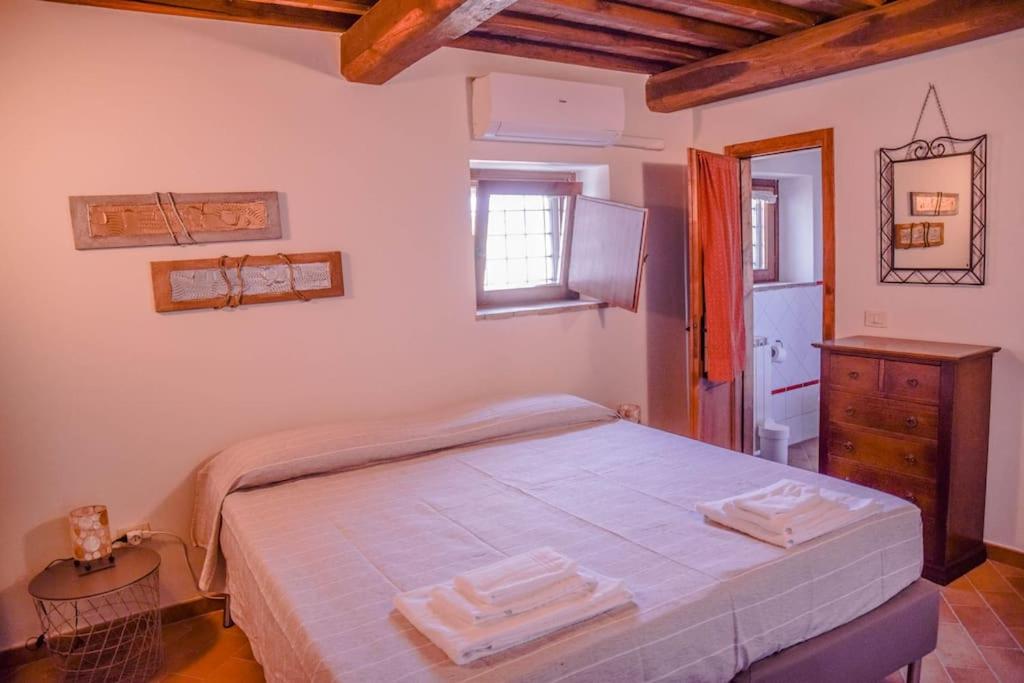 une chambre avec un lit avec deux serviettes dessus dans l'établissement Tofelli villa with private pool, quiet and panoramic view, à Amelia