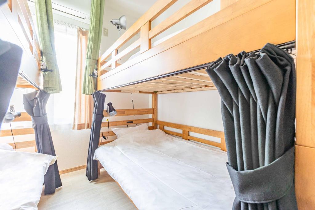 une chambre avec un lit superposé dans une pièce dans l'établissement add-Hostel Uji Cha-gan-ju-tei, à Uji
