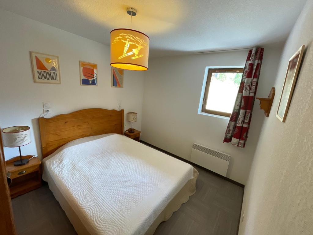 une petite chambre avec un lit et une fenêtre dans l'établissement Appartement Vars sur les pistes de ski avec piscine, à Sainte-Marie-de-Vars