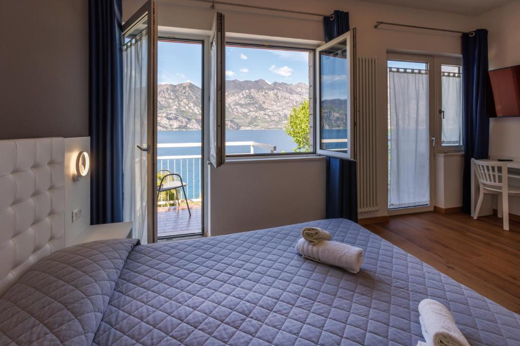 une chambre avec un lit avec un ours en peluche dessus dans l'établissement Hotel Al Molino, à Malcesine