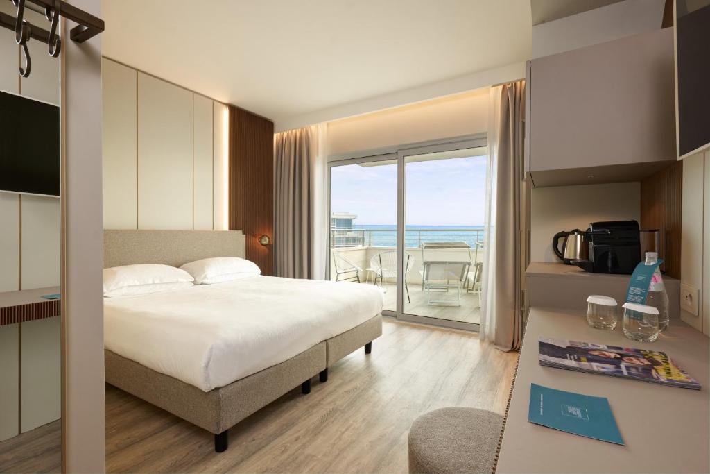 une chambre avec un lit et une vue sur l'océan dans l'établissement Adriatic Palace Hotel, à Lido di Jesolo