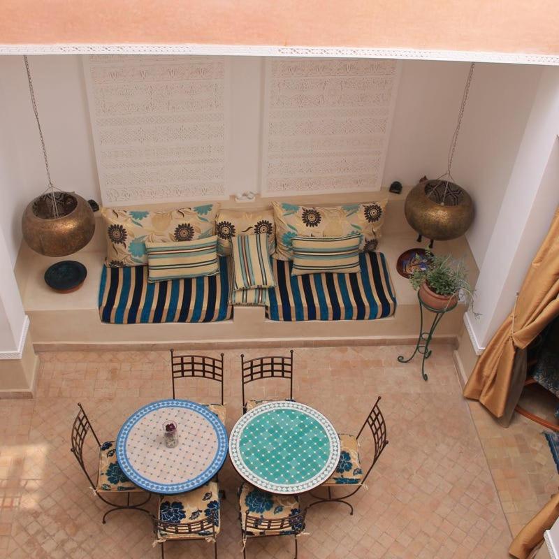 une chambre avec deux tables, des chaises et un canapé dans l'établissement Dar 14 Marrakech, à Marrakech