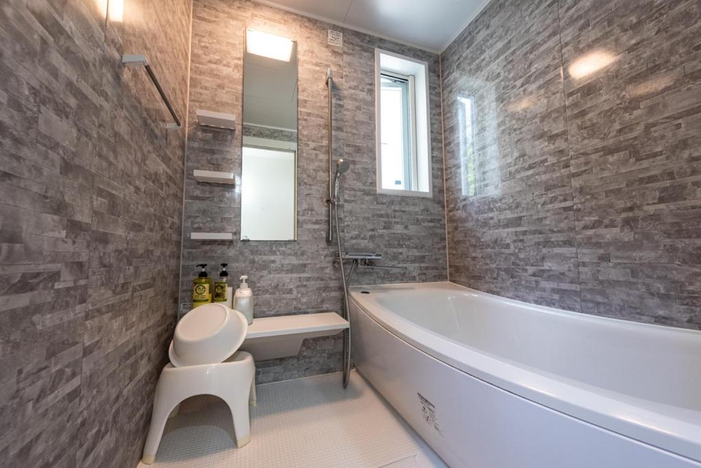 une salle de bain avec une baignoire, des toilettes et un lavabo dans l'établissement Fujimien, à Fujikawaguchiko