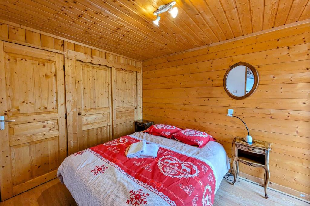 une chambre avec un lit dans une cabane en bois dans l'établissement Spacieux appartement au centre de la station, à Les Déserts 12 autres photos