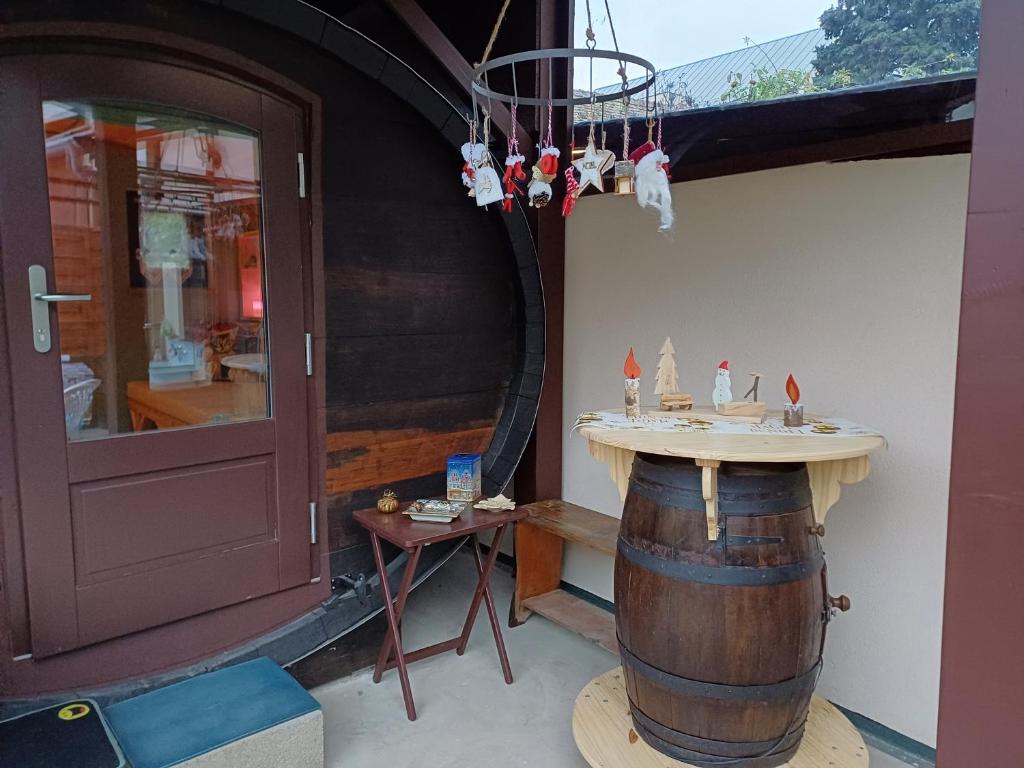 un tonneau de vin avec une table avec des bateaux miniatures. dans l'établissement Le coup de foudre, à Barr