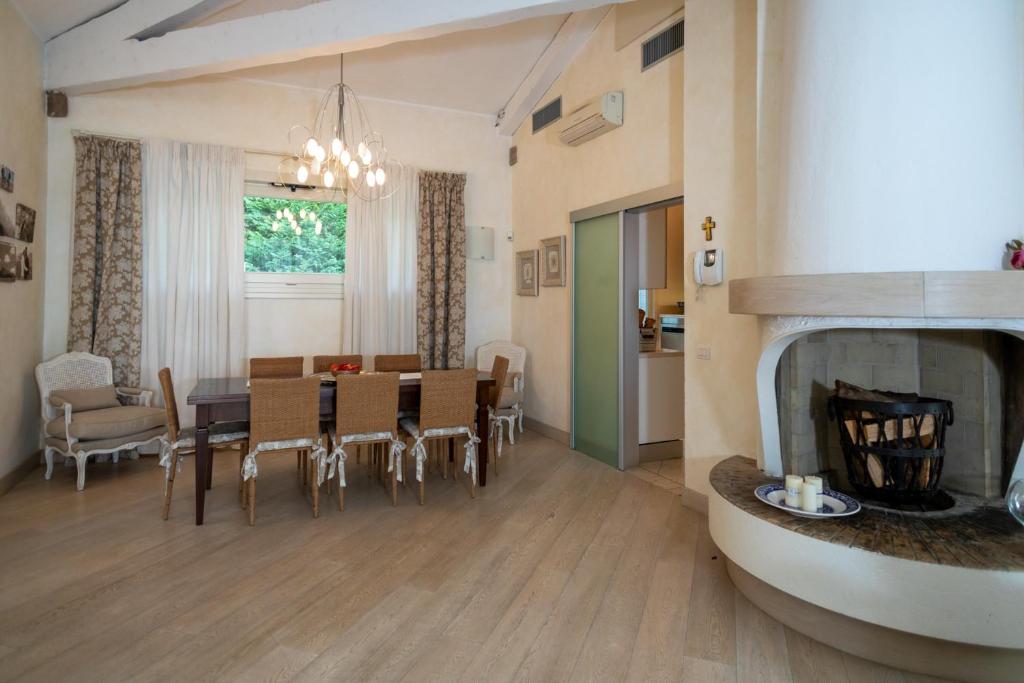 - une salle à manger et un salon avec une table et une cheminée dans l'établissement VILLA INFINITY - Regarda Travel, à Bardolino 38 autres photos