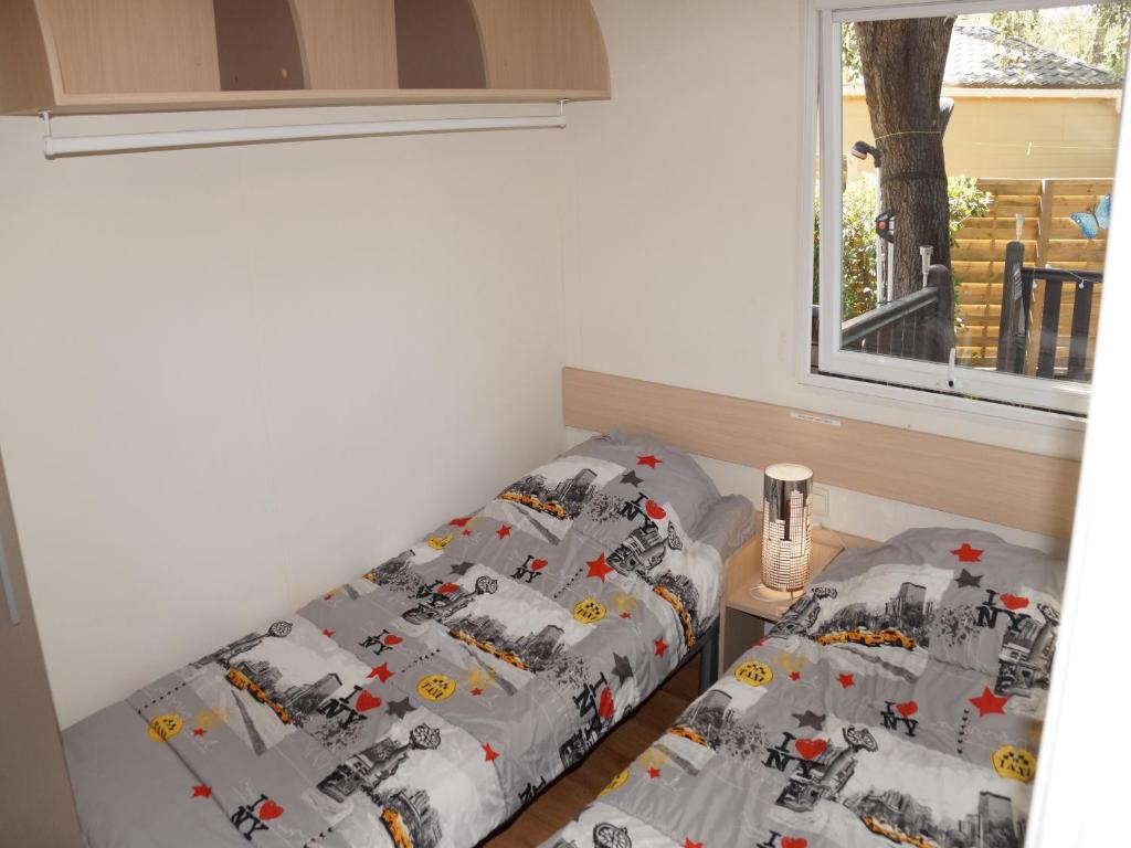 une chambre avec deux lits jumeaux et une fenêtre dans l'établissement Le TropeZen Confort Plus TV WIFI VOD Salle de Sport !, à Gassin