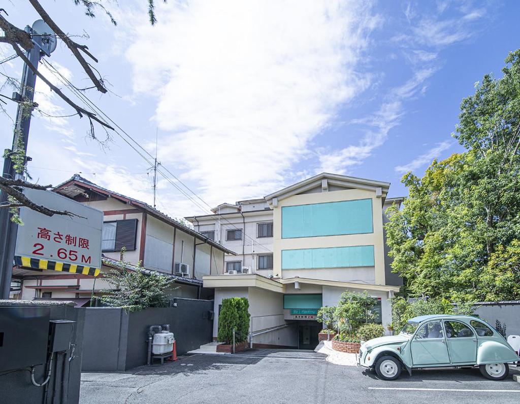 une voiture garée sur un parking devant un immeuble dans l'établissement Hotel Jardin de Fleurs (Adult Only), à Kyoto