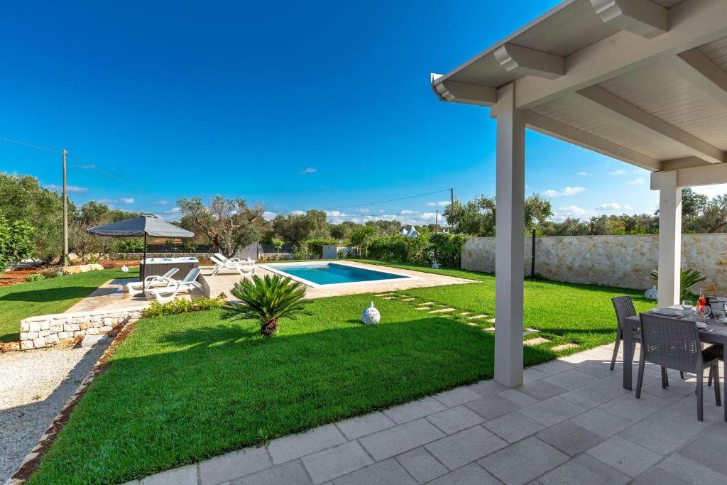 une cour avec une piscine et une pergola dans l'établissement Villa Angi by Perle di Puglia, à San Vito dei Normanni