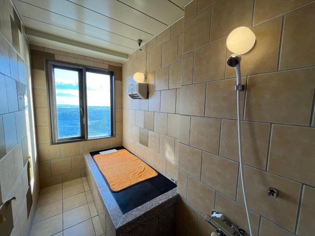 - une petite salle de bains avec un banc dans la douche dans l'établissement LiVEMAX RESORT Shiretoko Sea Front, à Rausu 30 autres photos