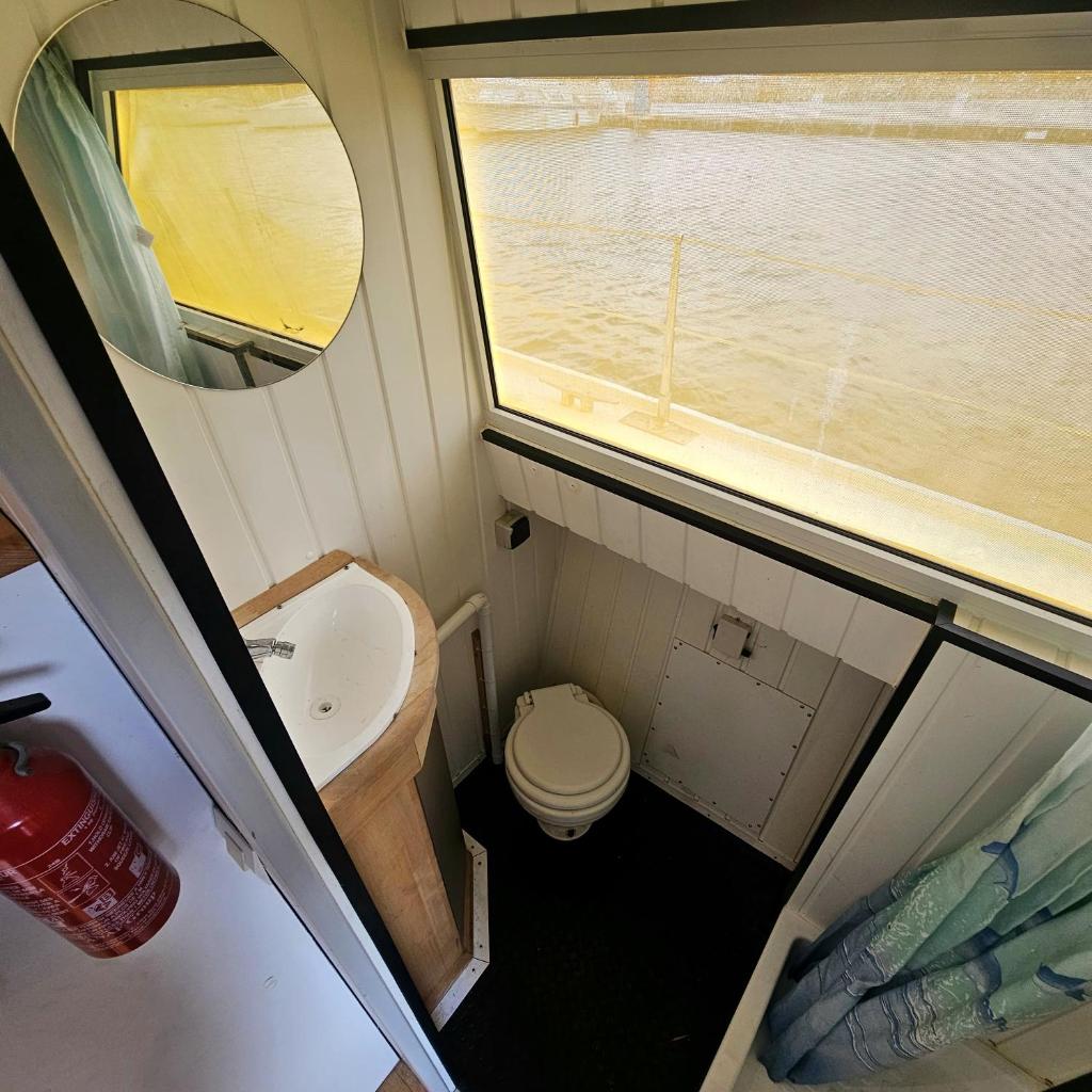 une petite salle de bain avec un lavabo et des toilettes dans l'établissement Appartement sur l'eau tout confort, au Barcarès 20 autres photos