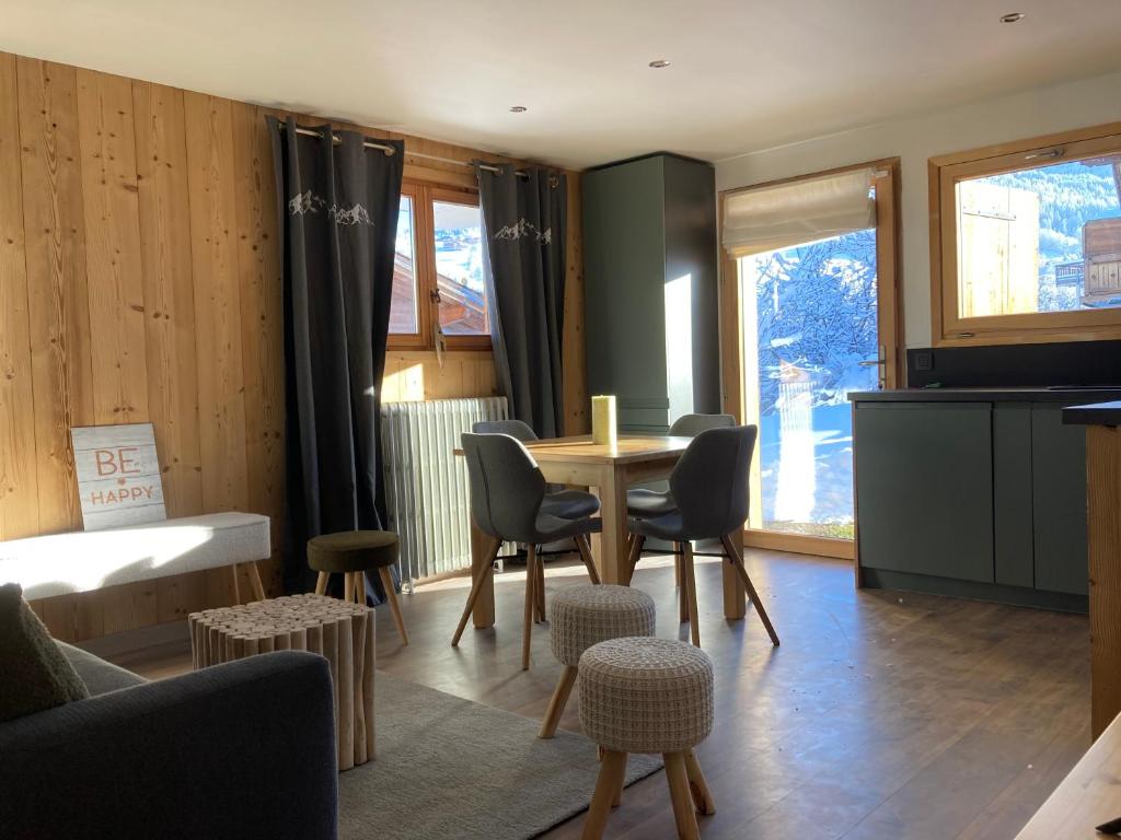 un salon avec une table et des chaises dans l'établissement Renovated flat facing Mont Blanc, à Combloux