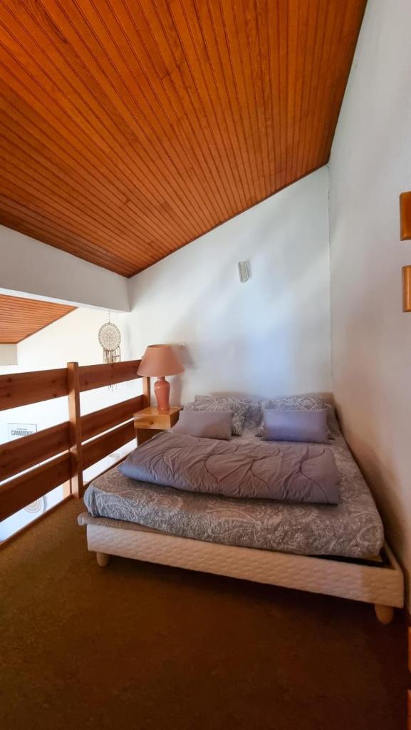 une chambre avec un lit et un plafond en bois dans l'établissement Apartment 6 people in the heart of Valberg resort, à Valberg