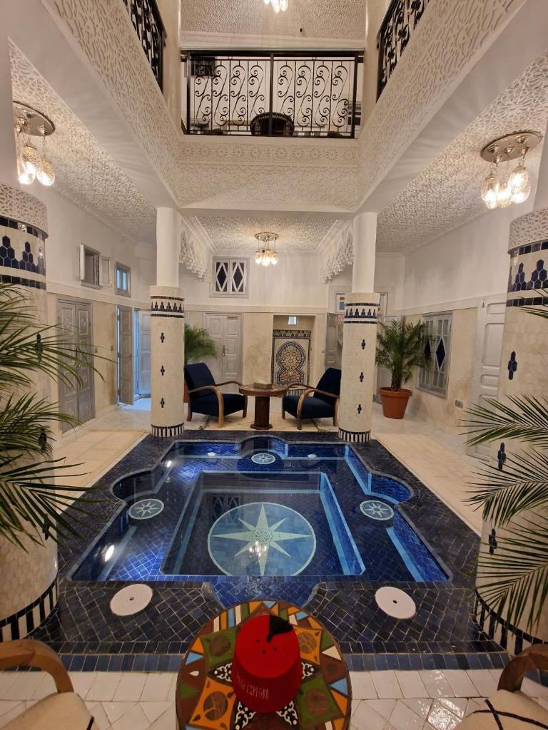 - un hall avec une piscine au milieu d'une pièce dans l'établissement Riad Explore, à Marrakech
