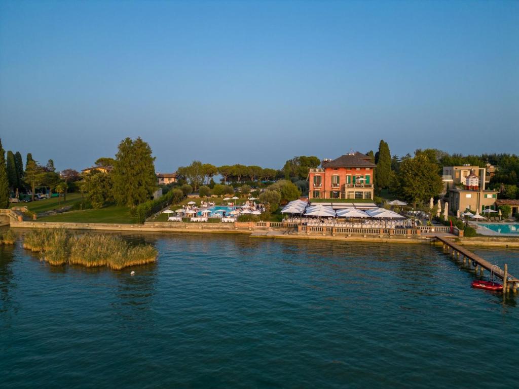 une vue aérienne sur une rivière avec des maisons et des bâtiments dans l'établissement Villa Pioppi Hotel, à Sirmione
