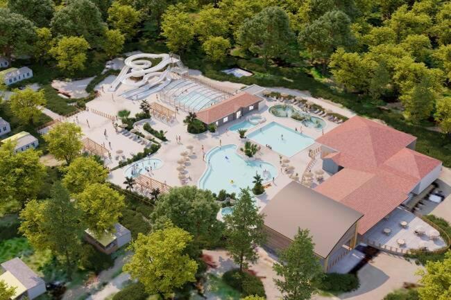 - une vue sur un grand bâtiment avec une piscine dans l'établissement Mobil Home Premium 3 ch Camping 5 Biscarrosse Mayotte F64, à Biscarrosse