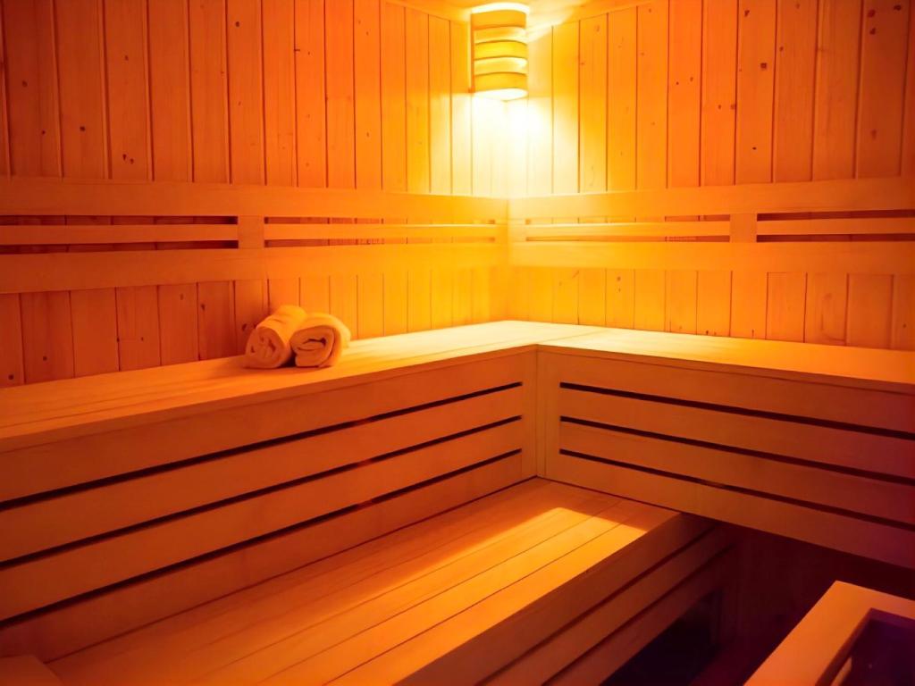 un sauna avec deux serviettes posées sur les étagères dans l'établissement LiVEMAX RESORT Kyotango Sea Front, à Kyōtango