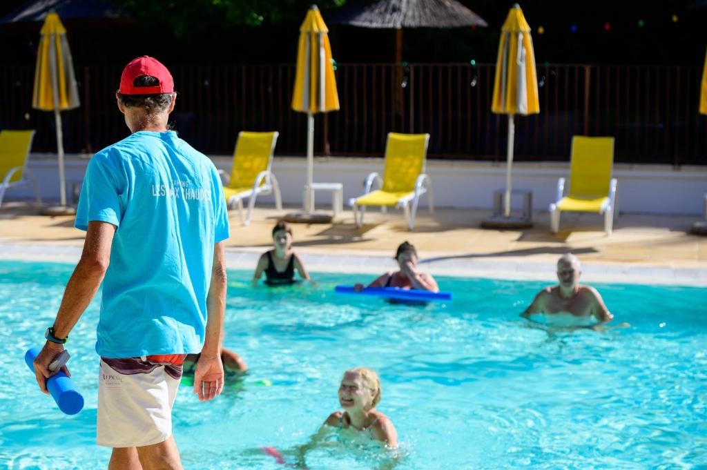 un homme debout dans une piscine avec un frisbee dans l'établissement Les Eaux Chaudes, à Digne-Les-Bains