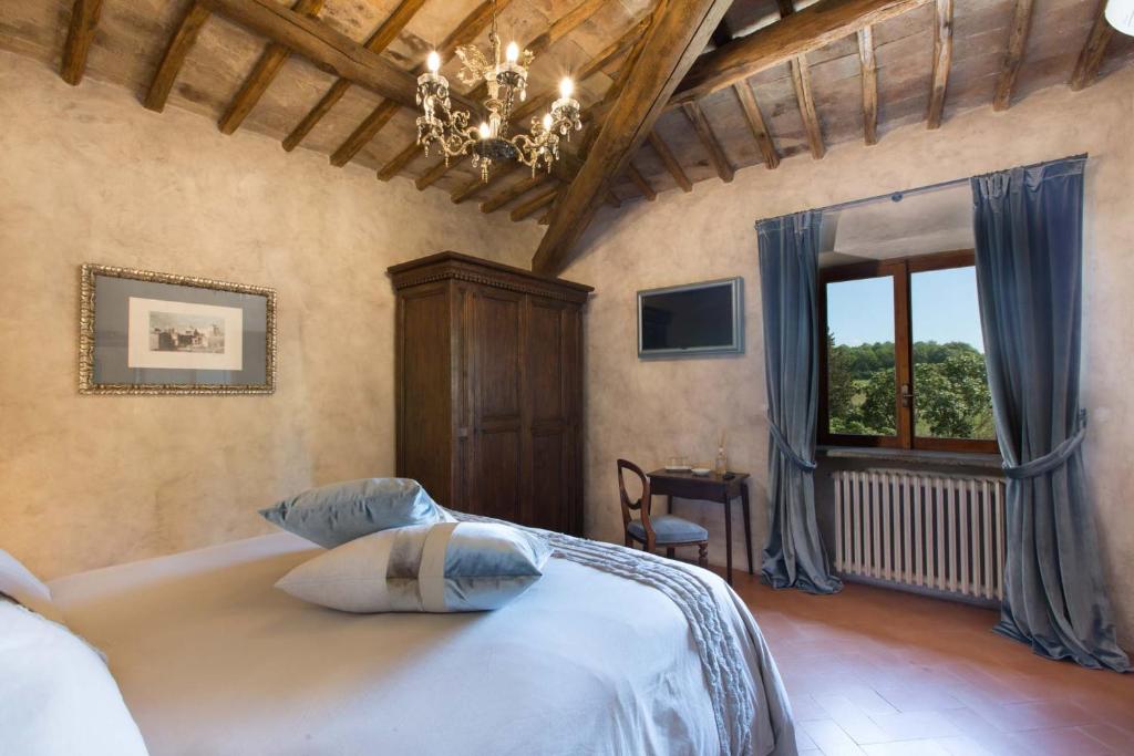 - une chambre avec un lit, un lustre et une fenêtre dans l'établissement Torre Collevento Luxury Villa, à Orvieto 50 autres photos