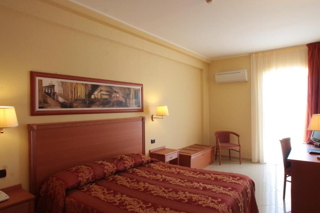 une chambre d'hôtel avec un lit et une fenêtre dans l'établissement Hotel Relais dei Normanni, à Monte SantʼAngelo