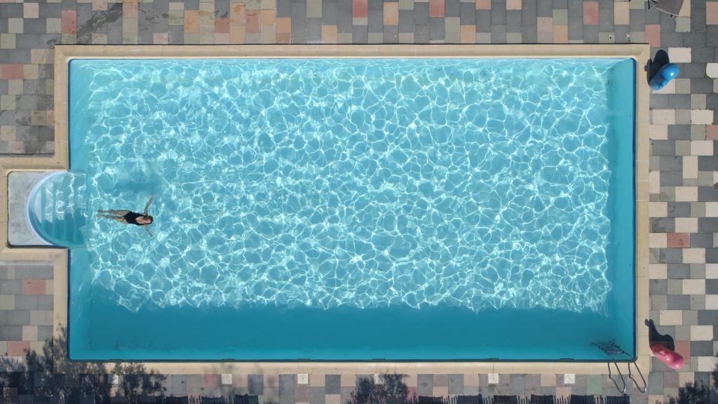 - une piscine avec une personne dans l'eau dans l'établissement Glamping Saint-Thomé, à Saint-Thomé