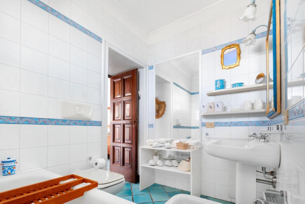 une salle de bain blanche avec un lavabo et des toilettes dans l'établissement YourHome - Villa Mia, à Massa Lubrense