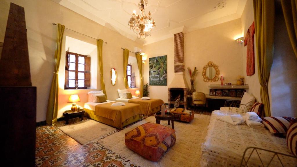 une chambre avec un lit et un salon dans l'établissement Riad Chambres D'Amis Marrakech, à Marrakech