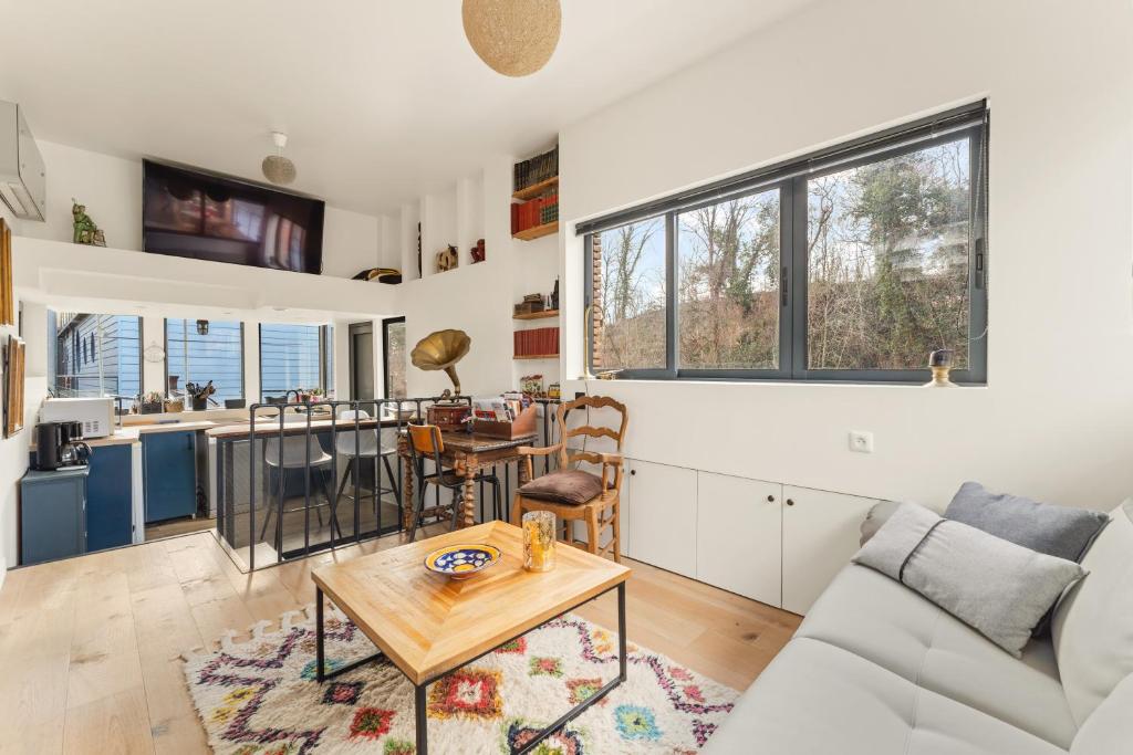 un salon avec un canapé et une table dans l'établissement Péniche, à Issy-les-Moulineaux