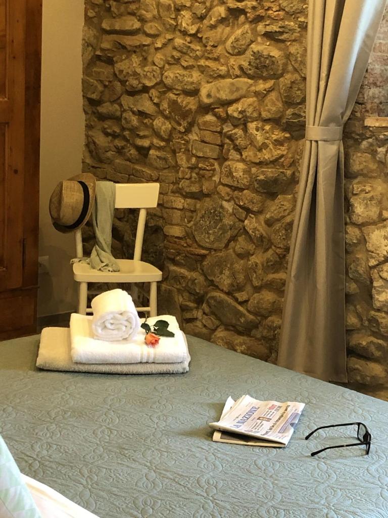 une table avec une chaise et un chapeau dessus dans l'établissement Villa Claudia, à Cavriglia